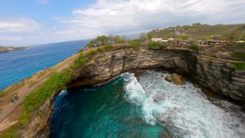FPV drone flight over Broken Beach arch and turquoise lagoon on Nusa Penida Bali Stock Footage 310223268