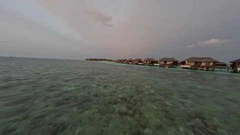 FPV Drone Flight Over Crystal Clear Ocean Near Overwater Villas in Maldives Stock Footage 346164952
