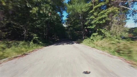 An F.P.V drone flight over a dirt road by New Croton Dam on a sunny day. A calm Stock Footage 346501033