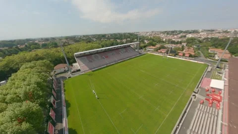 FPV drone flight over empty grass pitch at Parc des Sports Aguilera stadium Stockbeeldmateriaal 306365209