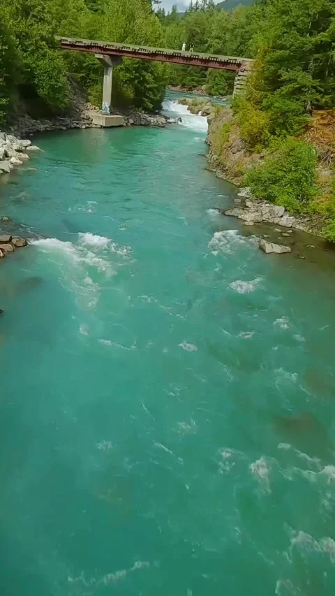 FPV drone flight over the fast moving river with rapids, close to the water. Stock Footage 320191391
