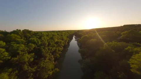 FPV drone flight over Kamchia River through dense forest at sunset in Bulgaria. Stock Footage 342544443