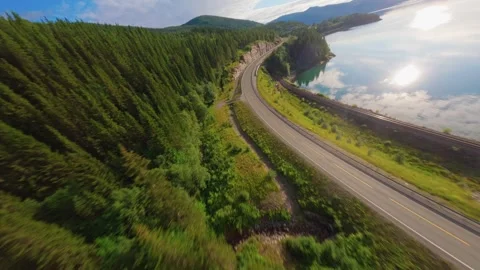 FPV Drone Flight Over Road Along Lake in Norway – Scenic Aerial Travel Shot Video stock 305802198