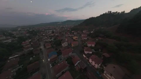 FPV drone flight over rooftops of Belitsa mountain town at sunset in Bulgaria. Stock Footage 343686083