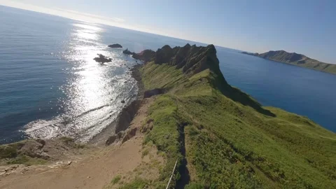 FPV Drone Flight Over Rugged Coastal Rocks and Sea in Rebun, Hokkaido, Japan Video stock 332302091