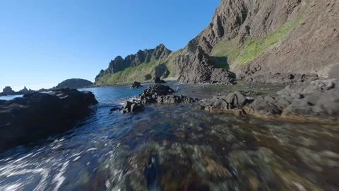 FPV Drone Flight Over Sky-Blue Sea and Rugged Cliffs of Rebun Hokkaido, Japan Video stock 332302055