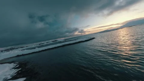 FPV Drone Flight Over Snowy Coast of Senja Norway at Sunset – Winter Aerial 4K Stock Footage 286998534