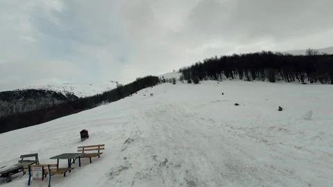 FPV Drone Flight Over Snowy Mountain Slope and Winter Forest 4K Stock Footage 328304565
