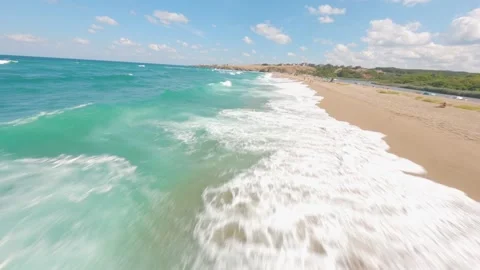 FPV drone flight over turquoise waves revealing Veleka Beach Stock Footage 342737395
