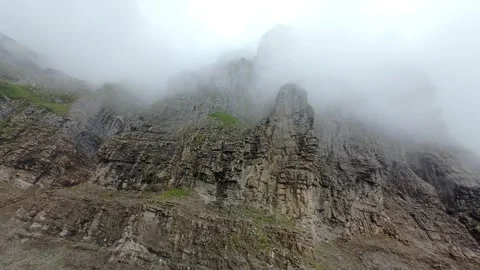 FPV Drone Flight Through Clouds Toward Swiss Mountain Cliffs Stock Footage 340613922