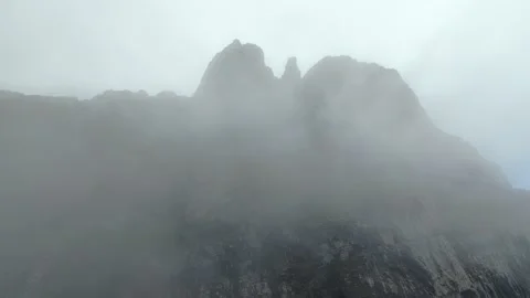 FPV Drone Flight Through Clouds Toward Swiss Mountain Cliffs Stock Footage 340617358
