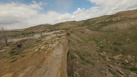 FPV Drone Flight Through Rocks and Trees to Lone Truck in Pasture Stock Footage 315974487