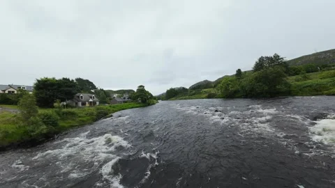 FPV drone flight under a road bridge then following the river upstream. Stock Footage 345212109