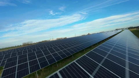 FPV drone flow skimming the surface of an expansive solar array in England Stock Footage 331555447