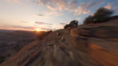 FPV Drone Flying Along Desert Ridge into Sunset Near Red Rocks Stock Footage 315975982