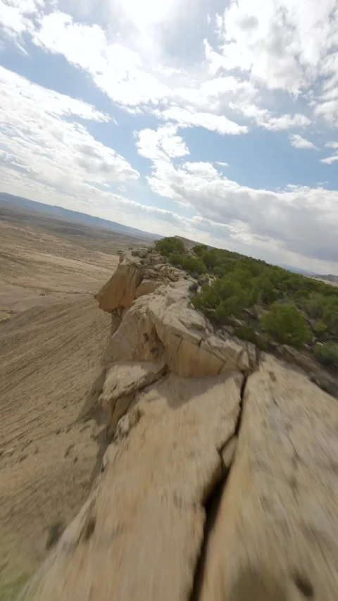 FPV Drone Flying Along Mountain Cliff Toward Pickup Truck on Desert Road Stock Footage 315974495