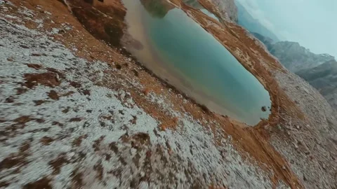 FPV drone flying along the surface of mountain cliffs of Cristallo mountain. Stockbeeldmateriaal 342958464