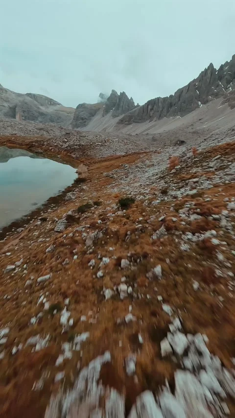FPV drone flying along the surface of mountain cliffs of Cristallo mountain. Video stock 342959526