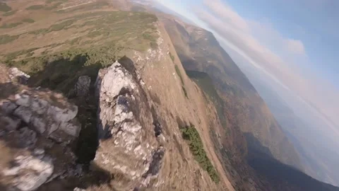 FPV drone flying around a drone pilot then goes really close to ground Stock Footage 169280636