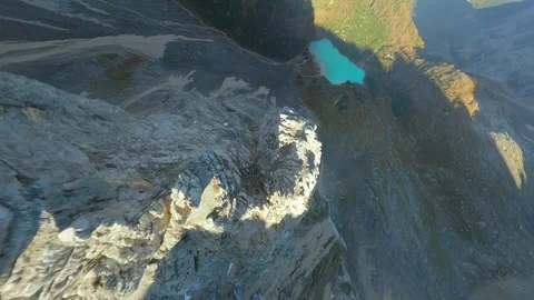 FPV drone flying close to the sharp mountain cliffs and Lago di Sorapis. Italy. Stock Footage 293637056