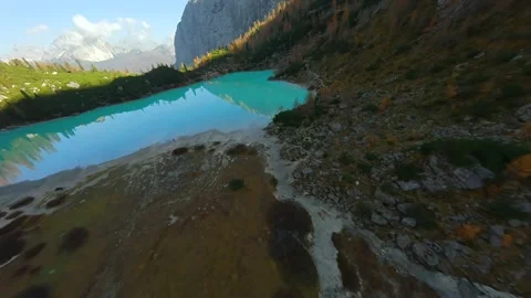 FPV drone flying close to the sharp mountain cliffs and Lake Sorapis. Italy. Stock Footage 304009400