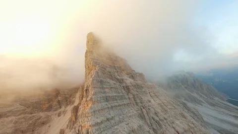 FPV drone flying in the clouds close to the mountain cliffs. Italy, Dolomites Stock Footage 304009371
