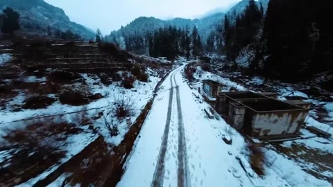 FPV drone flying fast between snowy mountain off piste. Stock Footage 259390157