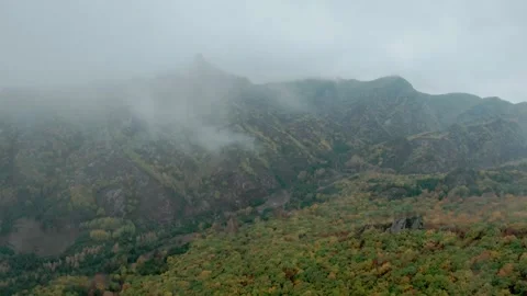 FPV drone flying fast through the clouds, with views of the autumn forest Stock Footage 293324924