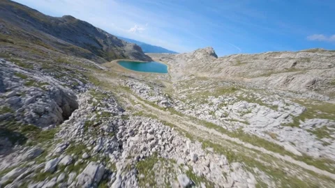 Fpv drone flying low to an artificial lake in French mountain Stock Footage 253553866