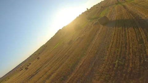 FPV drone flying over a field with bales Video stock 160749486