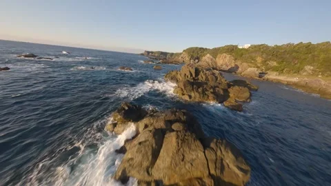 FPV drone flying over Kaikongo rocky coast at sunrise in Wakayama, Japan Video stock 331728860