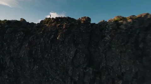 Fpv drone flying over a man on top of a mountain Stock Footage 168617501