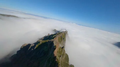 FPV drone flying over a mountain ridge surrounded by a sea of clouds Stock Footage 253555632