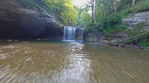 Fpv drone flying over river and multi layered waterfall cascade du herisson jura Stock Footage 281187978