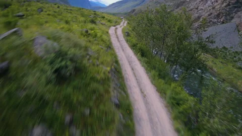 FPV drone flying over the road and the car. River and rocks Stock Footage 166059279