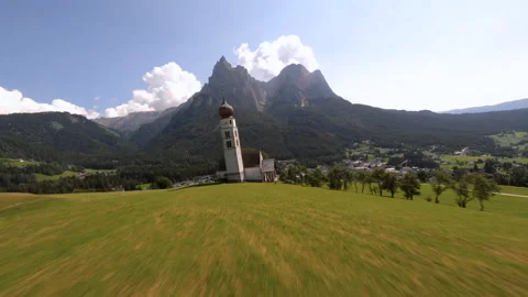 FPV drone flying over St Valentin Church in Dolomites Stock Footage 167061119