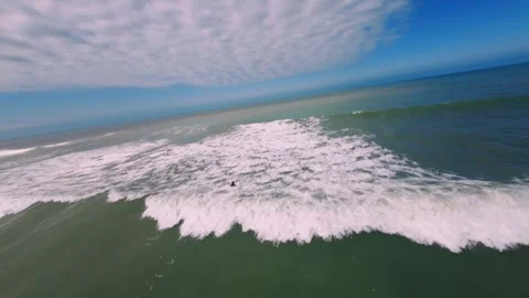 FPV DRONE FLYING OVER A SURFER IN THE SEA Stock Footage 263928051