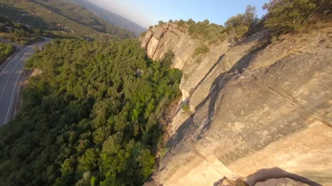 FPV drone flying over trees during sunset. Beautiful landscape with mountains in Stock Footage 215170034