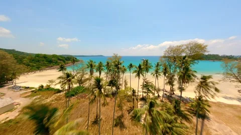 FPV drone flying over tropical palms coastline and white sandy beach. Stock Footage 249807945