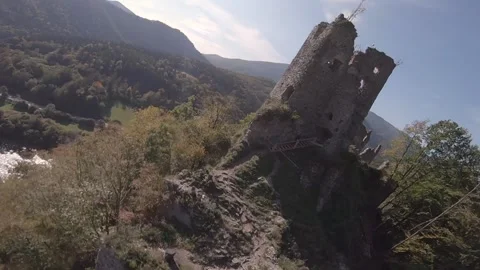 FPV drone flying really close around an ald ancient castle in green mountains Stock Footage 169280634