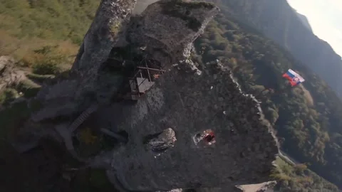 FPV drone flying really close to an ancient castle with a national flag Stock Footage 169280650