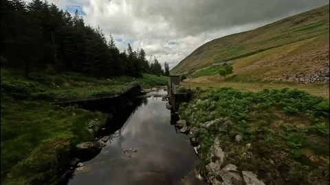 FPV Drone flying up a river to the top of Spelga Dam in Northern Ireland Stock Footage 245238188