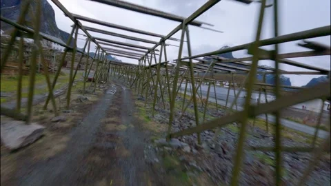 FPV Drone Flying Through Fish Racks in Norwegian Fishing Village 스톡 동영상 308729316