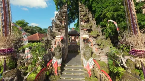 FPV drone flying through traditional Balinese temple entrance in Ubud, Bali Stock Footage 313774750