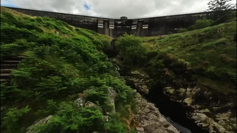 FPV Drone flying through trees and up Spelga Dam in Northern Ireland Stock Footage 245238250