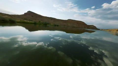 FPV Drone Flyover of Desert Mountain Lake with Trees and Reflections Stock Footage 315928083
