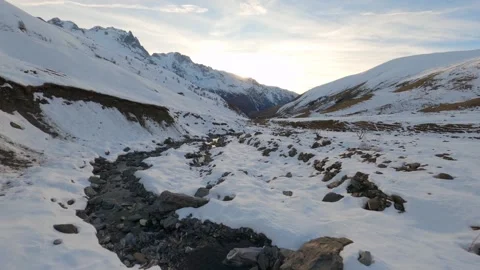 FPV drone follows the course of a small mountain river at sunrise Stock Footage 253554374