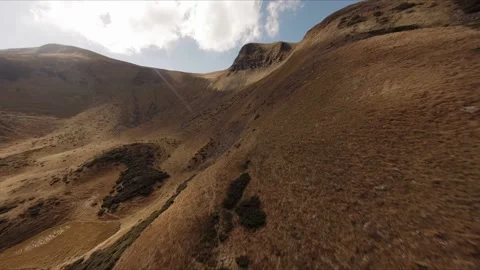 FPV Drone footage: Smooth Stabilized Fly along Mountain Rocky Hill around Stock Footage 162697334