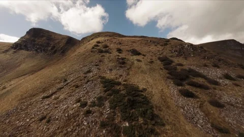 FPV Drone footage: Smooth Stabilized Fly along Mountain Rocky Hill around Stock Footage 162697469