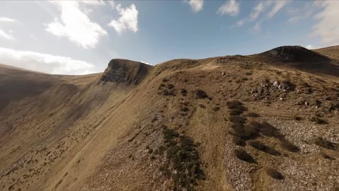 FPV Drone footage: Smooth Stabilized Fly along Mountain Rocky Hill around Stock Footage 162697531